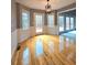 Spacious dining room with beautiful light fixture, hardwood floors, large windows and access to back deck at 866 Lee Byrd Rd, Loganville, GA 30052