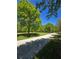 Long paved driveway leading to the property surrounded by mature trees at 866 Lee Byrd Rd, Loganville, GA 30052