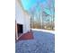 Exterior of home with white siding and stone driveway, leading to trees in the distance at 866 Lee Byrd Rd, Loganville, GA 30052