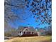 Rear view of home featuring a spacious deck, perfect for outdoor living, and a well-manicured lawn at 866 Lee Byrd Rd, Loganville, GA 30052