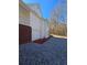 Two-story home featuring brick accents, vinyl siding, and a gravel driveway at 866 Lee Byrd Rd, Loganville, GA 30052