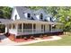 Charming home features a welcoming porch, beautiful landscaping, and fresh curb appeal at 866 Lee Byrd Rd, Loganville, GA 30052