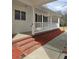 Cozy front porch with brick accents and a white railing, enhancing the home's curb appeal at 866 Lee Byrd Rd, Loganville, GA 30052