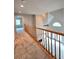 Hallway with wood railing overlooking the living room below at 866 Lee Byrd Rd, Loganville, GA 30052