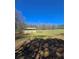 Backyard with trees and shed under bright blue sky at 866 Lee Byrd Rd, Loganville, GA 30052