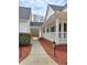 Exterior walkway connecting different parts of the house, surrounded by mulch landscaping at 866 Lee Byrd Rd, Loganville, GA 30052