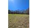 A large grassy field with a storage building in the background at 866 Lee Byrd Rd, Loganville, GA 30052