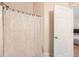 Bathroom featuring a shower with a stylish curtain and a convenient door to the bedroom at 1342 Orchard Park Dr, Stone Mountain, GA 30083