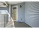Private entrance with light blue siding, screened door, and wrought iron railing at 1342 Orchard Park Dr, Stone Mountain, GA 30083