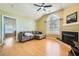 Open living room featuring hardwood floors, fireplace, large window, and gray sectional sofa at 1342 Orchard Park Dr, Stone Mountain, GA 30083