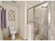 Walk-in tiled shower and toilet in a well-lit bathroom at 2203 Fullers Aly, Kennesaw, GA 30144