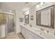 Bathroom featuring double sinks, white cabinetry, and tiled walk-in shower at 2203 Fullers Aly, Kennesaw, GA 30144