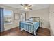 Bright bedroom features hardwood floors, a ceiling fan, and a window offering ample natural light at 2203 Fullers Aly, Kennesaw, GA 30144