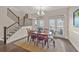 Spacious dining area with hardwood floors, chandelier, and a staircase adds architectural interest at 2203 Fullers Aly, Kennesaw, GA 30144