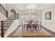 Inviting dining room featuring hardwood floors, a chandelier, and adjacent staircase for an open feel at 2203 Fullers Aly, Kennesaw, GA 30144