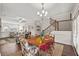 Open-concept dining area flows into the living space, featuring hardwood floors and ample natural light at 2203 Fullers Aly, Kennesaw, GA 30144
