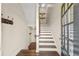 Welcoming entryway with hardwood stairs, a coat rack, and a glimpse into the home's bright interior at 2203 Fullers Aly, Kennesaw, GA 30144