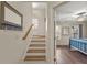 Inviting entryway featuring hardwood stairs leading to the upper level, and a bedroom visible on the right at 2203 Fullers Aly, Kennesaw, GA 30144