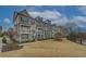Charming townhomes with brick facade, white trim, and small private balconies create an inviting curb appeal at 2203 Fullers Aly, Kennesaw, GA 30144