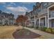 Street view of townhomes with brick exteriors, walkways, and well-maintained landscaping at 2203 Fullers Aly, Kennesaw, GA 30144