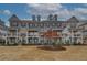 Attractive townhome exteriors showcasing brick, dormers, shutters, and well-manicured landscaping at 2203 Fullers Aly, Kennesaw, GA 30144