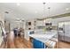 Modern open-concept kitchen with stainless appliances, white cabinets, and a large island at 2203 Fullers Aly, Kennesaw, GA 30144