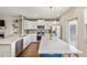 Bright kitchen with white cabinetry, stainless steel appliances, and a large island, seamlessly connected to the living room at 2203 Fullers Aly, Kennesaw, GA 30144