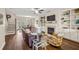 Bright living room features hardwood floors, a fireplace with built-ins, and easy access to the dining area and balcony at 2203 Fullers Aly, Kennesaw, GA 30144