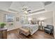 Bedroom features a tray ceiling, hardwood floors, and bright windows at 2203 Fullers Aly, Kennesaw, GA 30144