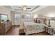 Bedroom features a tray ceiling, hardwood floors, and bright windows at 2203 Fullers Aly, Kennesaw, GA 30144