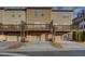 Back view of townhomes with decks over garages, and individual driveways at 2203 Fullers Aly, Kennesaw, GA 30144