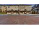 Townhome complex rear view featuring private garages and decks accessible by stairs at 2203 Fullers Aly, Kennesaw, GA 30144