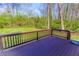Wooden deck overlooking the backyard with a grassy area surrounded by trees at 2904 Pleasant Ridge Dr, Decatur, GA 30034