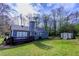 View of the backyard with a deck, shed, and lush green lawn at 2904 Pleasant Ridge Dr, Decatur, GA 30034