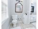 Bright bathroom with a toilet and a classic vanity placed next to a window at 2904 Pleasant Ridge Dr, Decatur, GA 30034