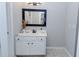 Bright bathroom featuring a stylish vanity with black framed mirror and neutral decor at 2904 Pleasant Ridge Dr, Decatur, GA 30034