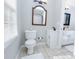 Well-lit bathroom with a white toilet, tile flooring, and dual sinks at 2904 Pleasant Ridge Dr, Decatur, GA 30034