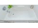A clean bathtub with chrome fixtures and a small potted plant on the ledge at 2904 Pleasant Ridge Dr, Decatur, GA 30034