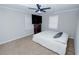 Cozy bedroom features a ceiling fan, large television, and neutral carpeting at 2904 Pleasant Ridge Dr, Decatur, GA 30034