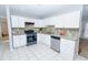 Well-lit kitchen with stainless steel appliances, granite countertops, and tile flooring at 2904 Pleasant Ridge Dr, Decatur, GA 30034