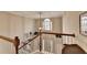 View of a staircase with wooden railings, leading to an open foyer with large windows at 3300 Oak Hampton Way, Duluth, GA 30096