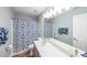 Bathroom with a double sink vanity, a blue and white shower curtain and towel at 3831 Portland Trail Dr, Suwanee, GA 30024