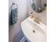 Pedestal sink bathroom with silver faucet, hanging towel and decorative mirror at 3831 Portland Trail Dr, Suwanee, GA 30024