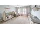 Bedroom with two windows, pink curtains, plush armchair, crib and decorative toys at 3831 Portland Trail Dr, Suwanee, GA 30024