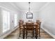Dining room showcases a large table, seating for six, modern lighting, and access to the outdoor area at 3831 Portland Trail Dr, Suwanee, GA 30024