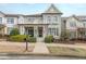 Charming two-story townhome featuring inviting front porch, a second story balcony, and landscaped front yard at 3831 Portland Trail Dr, Suwanee, GA 30024