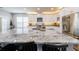 Spacious kitchen with a large granite island, stainless steel appliances, and white cabinetry at 3831 Portland Trail Dr, Suwanee, GA 30024
