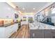 Well-lit kitchen with stainless steel appliances, a granite island, and stylish white cabinetry at 3831 Portland Trail Dr, Suwanee, GA 30024