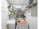 Well-organized laundry room with washer, dryer, and ample shelving for storage at 3831 Portland Trail Dr, Suwanee, GA 30024
