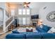 Inviting living room featuring a fireplace, large windows, and a comfortable blue sofa at 3831 Portland Trail Dr, Suwanee, GA 30024